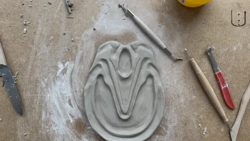 Ein Ornament aus Ton wird auf einem Tisch geformt
